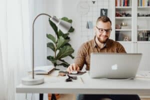 man looking at his laptop