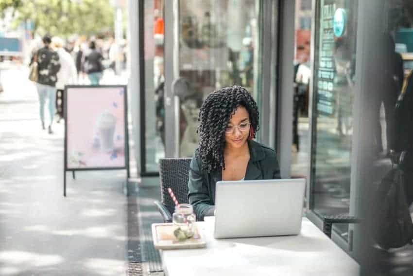 UoPeople female student on laptop with a master’s in business