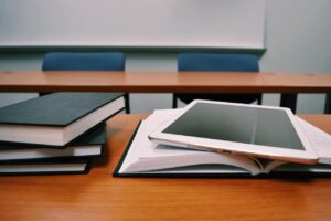 Books and tablet on desk in class for economics majors”