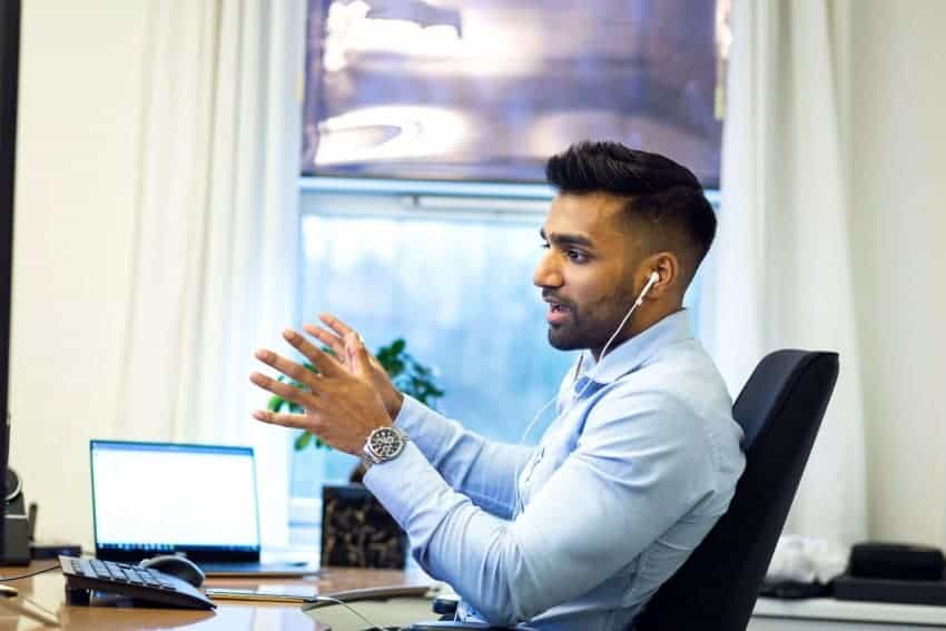 Man in office with an MBA degree from University of the People