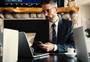 Man in black suit holding phone