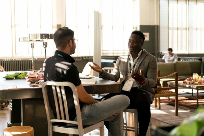 These two students are sharing a laugh together in the dorms.