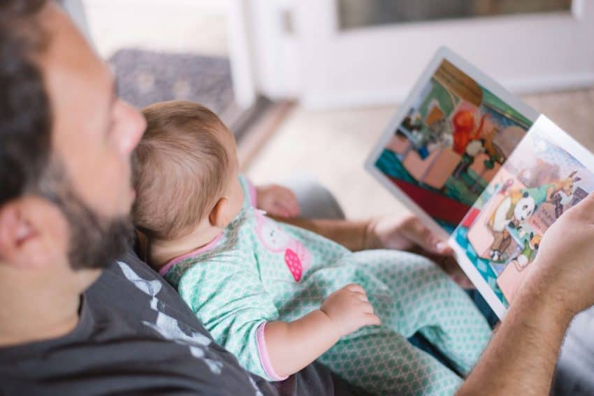 Dad reading to baby