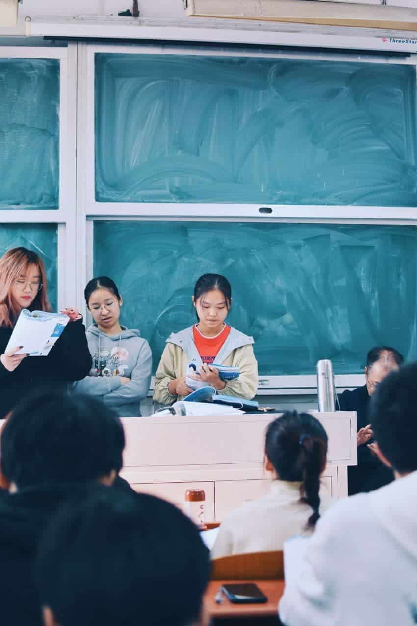 Students in front of a classroom presenting