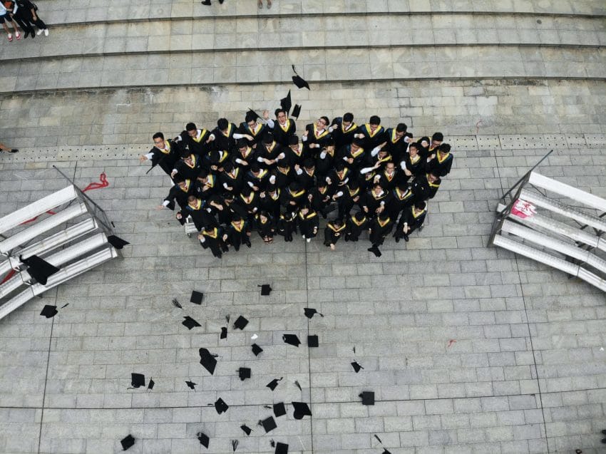 Group of graduates throwing their hats in the air