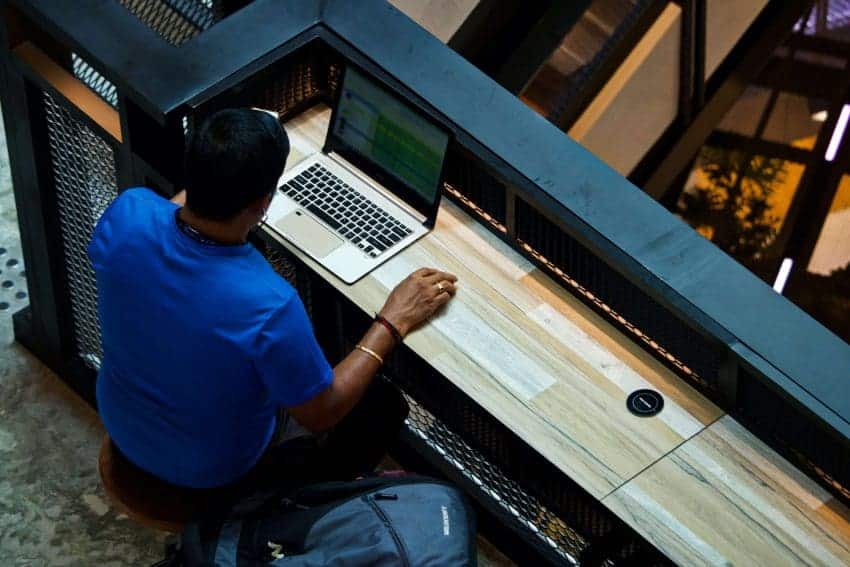 Person working on a spreadsheet on a laptop