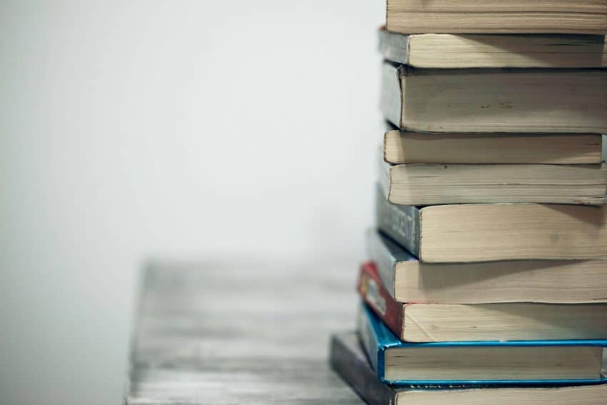 Stack of textbooks on table