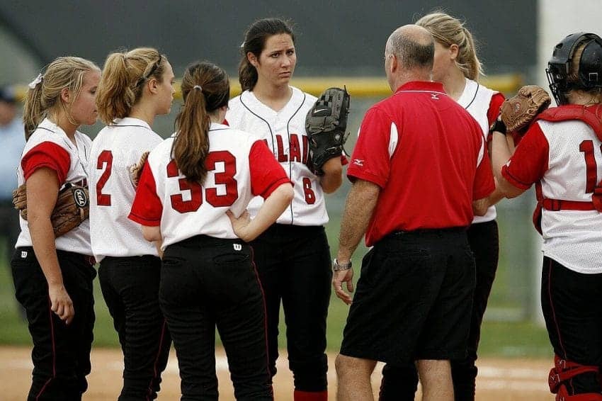 Athletic coach coaching a softball team