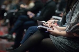 Student taking notes at a fellowship seminar