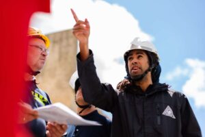 energy engineer in a hard hat with employees