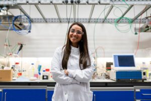 woman in a white coat and glasses in a lab