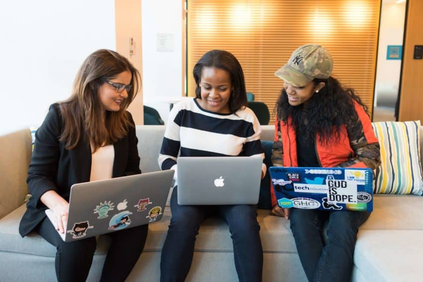 “Three University of the People students discussing at a table”