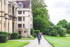 student walking in front of university