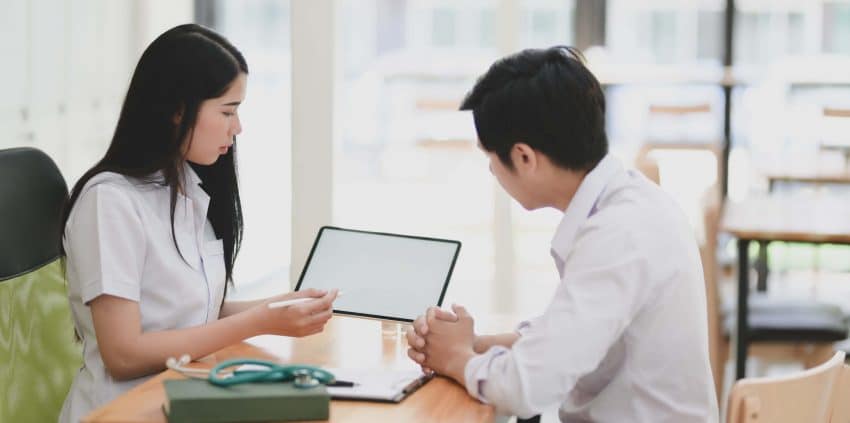 Epidemiologists working together at desk with tablet