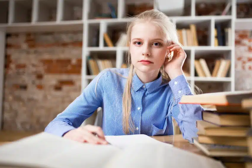 University of the People student studying at library