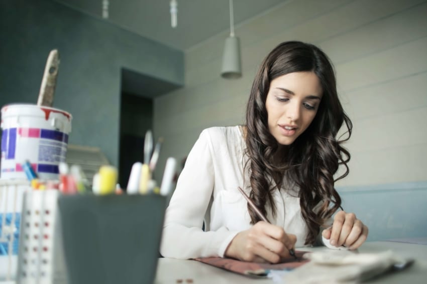 A female student at the University of the People writing in shorthand.