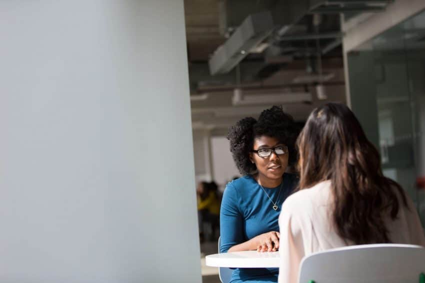 Counselor and care seeker sitting at table