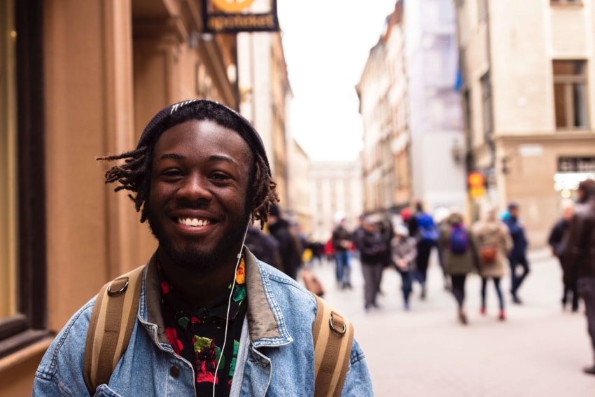 University of the People student smiling with backpack