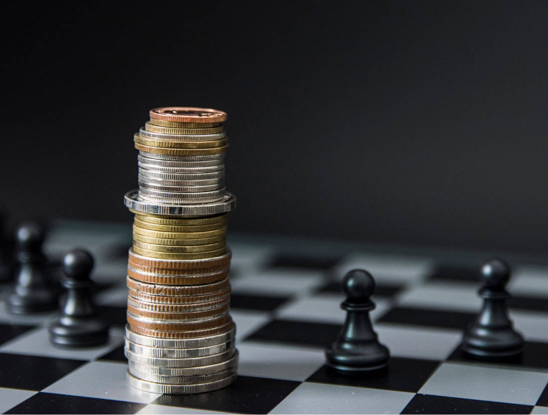 coin stacked with chess pawn