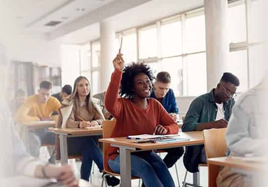 Student raising hands to answer