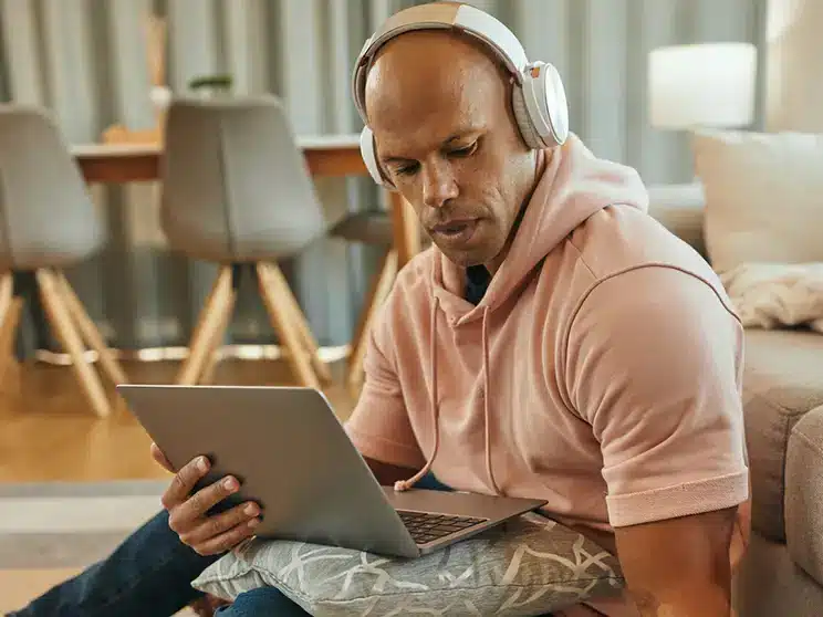 male student studying online using a laptop