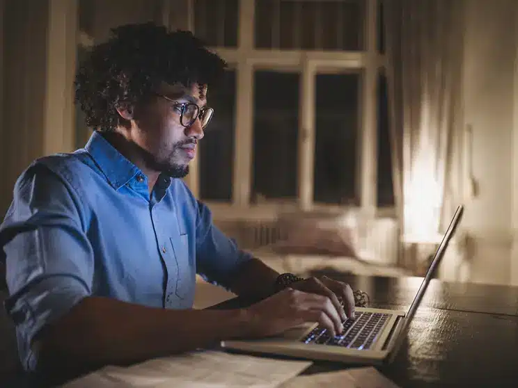 male college student studying online at a remote university