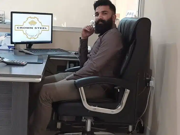 a successful male network administrator working at Crown Steel, Saudi Arabia