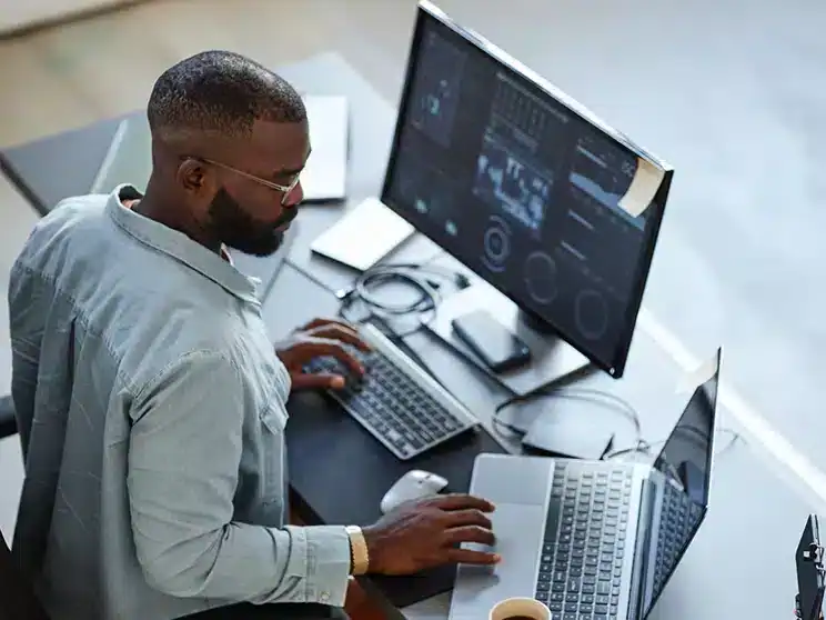 a male computer science professional seated at his workdesk