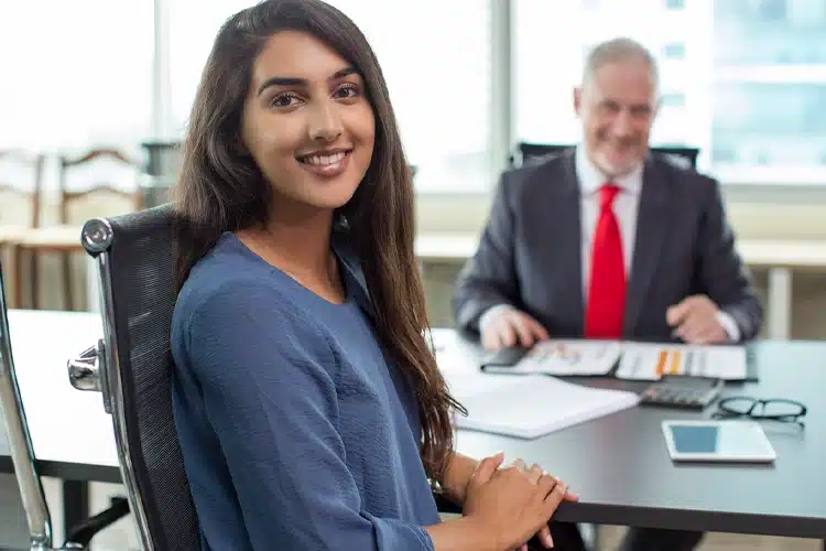 a female HR professional seated with her boss in an office