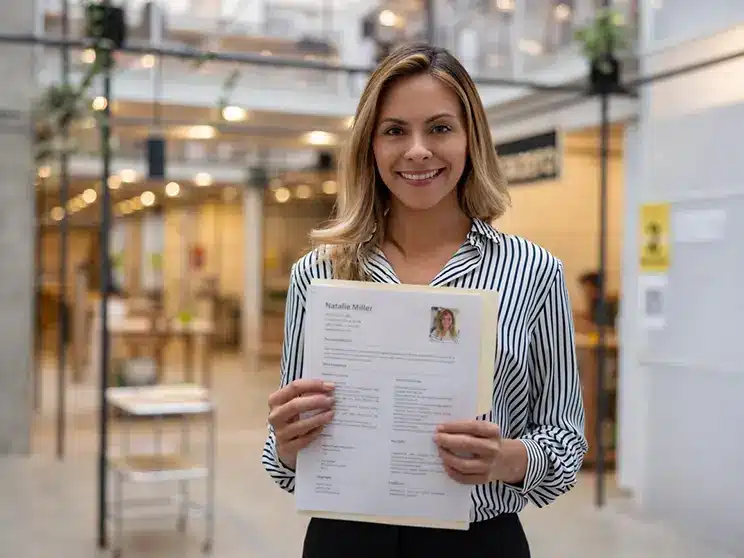 a female job applicant posing with her  CV in her hands