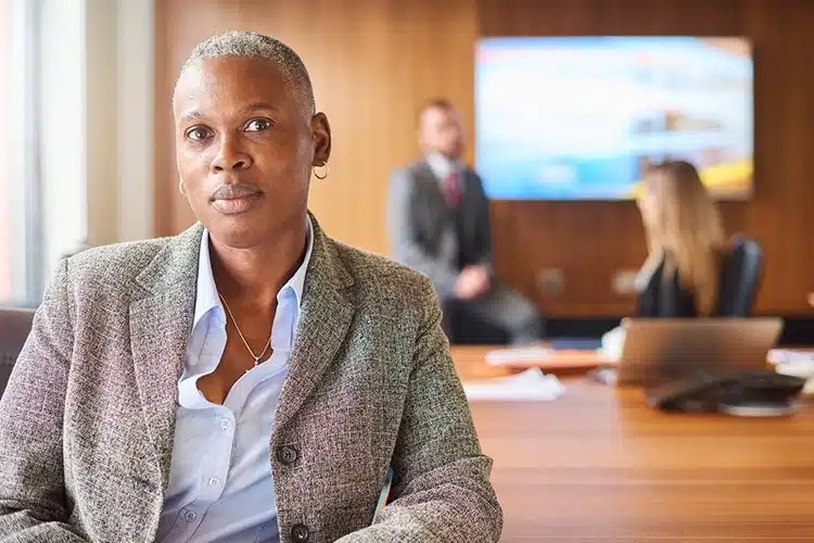 a corporate leader seated in a conference room