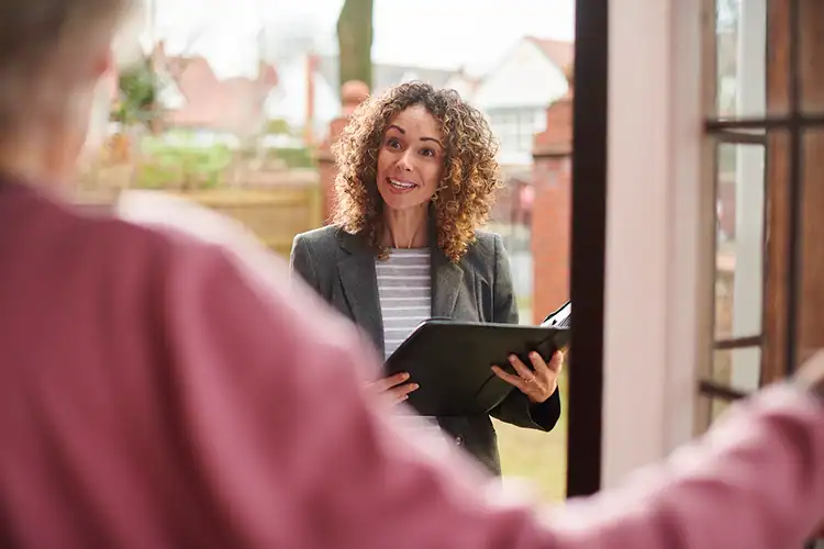 a senior female social worker verfifying records