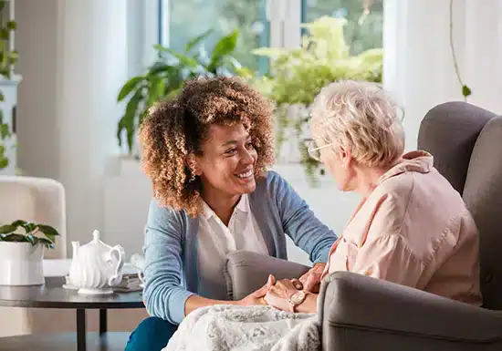 a female social worker attending to an older patient