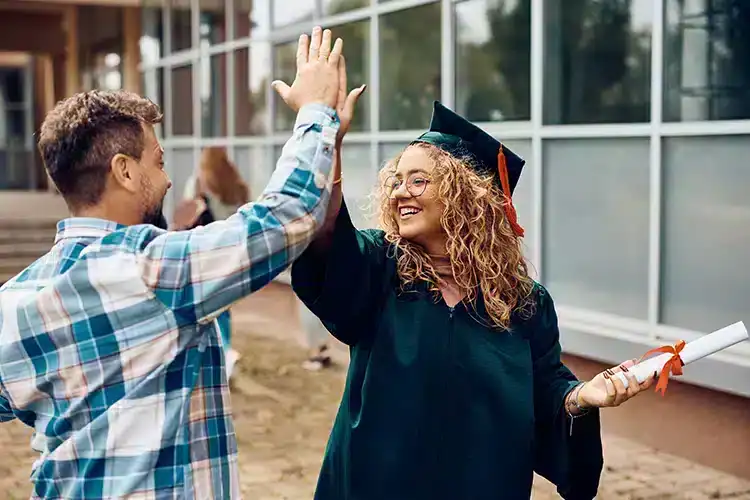 two bachelor's degree students celebrating their success