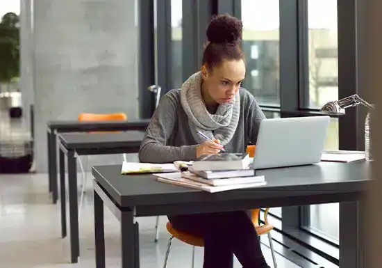 an online college aspirant researching college accreditations to enroll in an online program