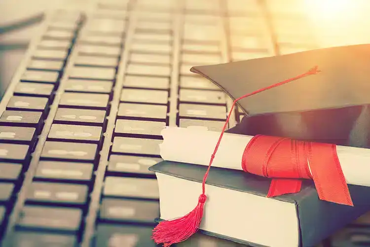 a graduation cap and degree document