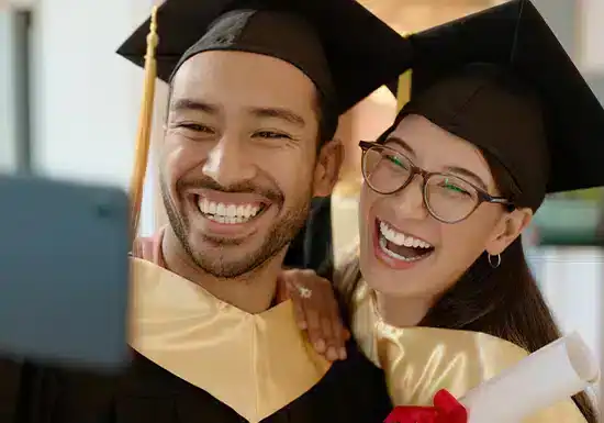 two working adults celebrating the degree they have earned from an online tuition-free school