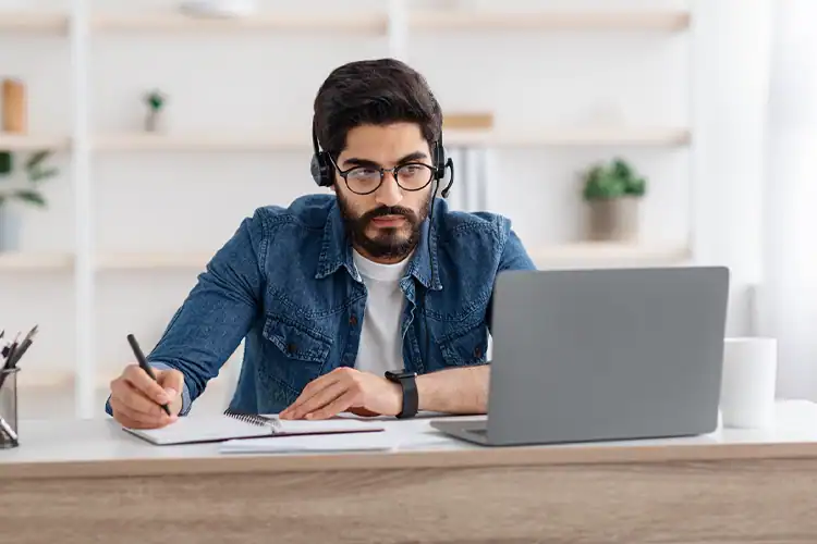 a male master's degree student earning his degree at an online school