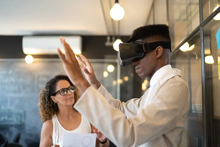 Young student using virtual reality headset in a classroom setting with a teacher observing.